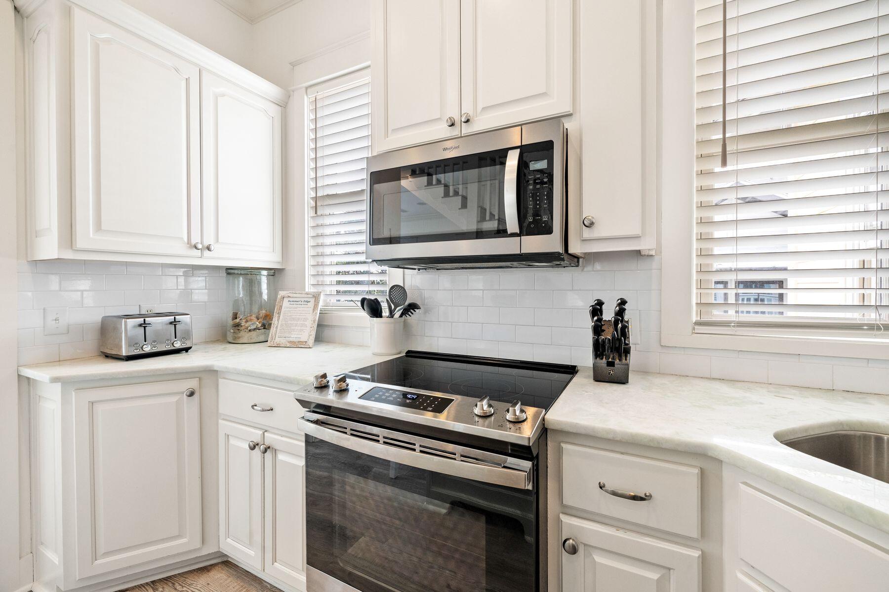 48 Chelsea Loop Road Santa Rosa Beach, FL 32459 - Photo 16 of 37 a kitchen with granite countertop white cabinets and appliances