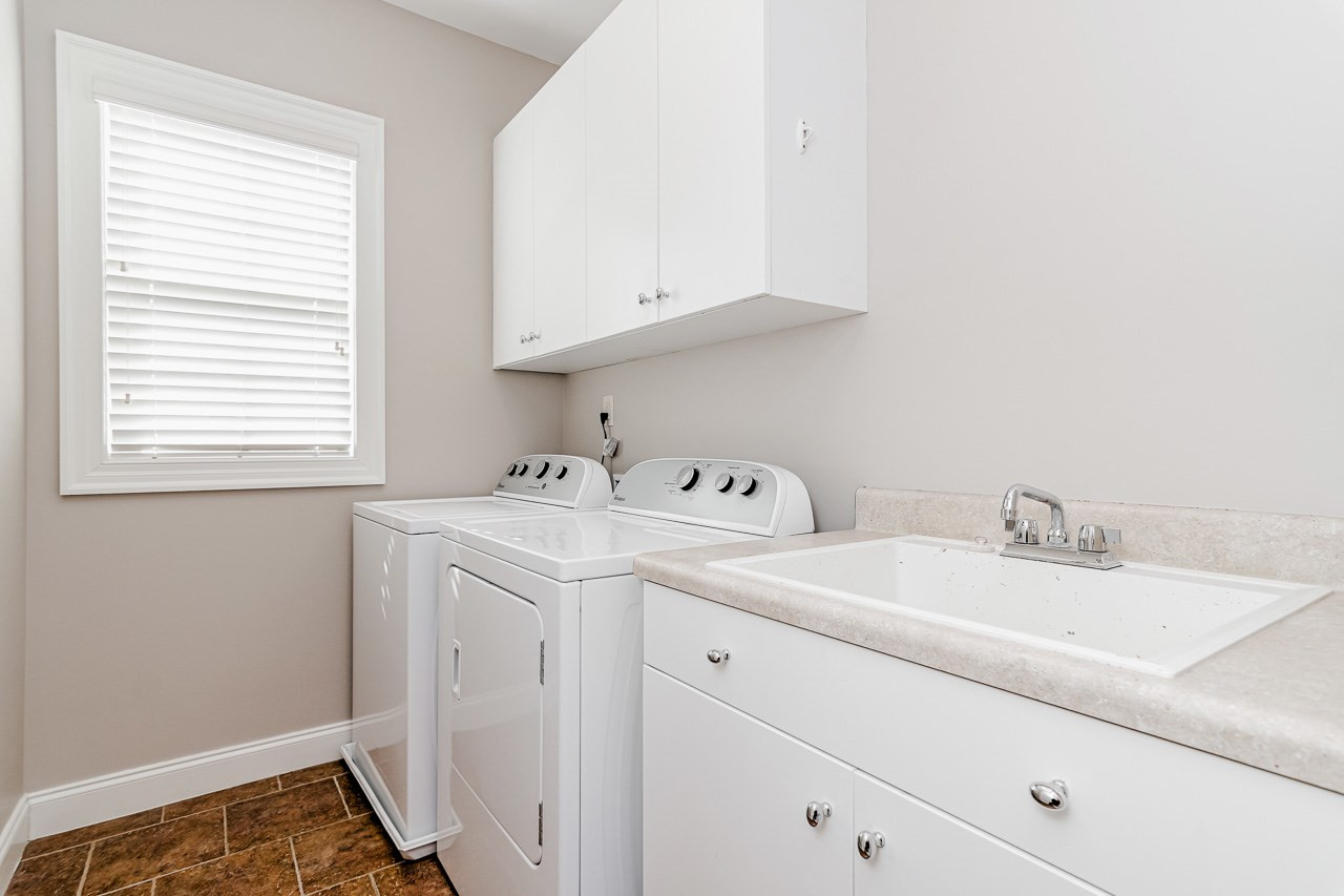 304 Redhill Road Holly Springs, NC 27540 - Photo 22 of 30 Laundry Room with a utility sink and cabinets Laundry Room