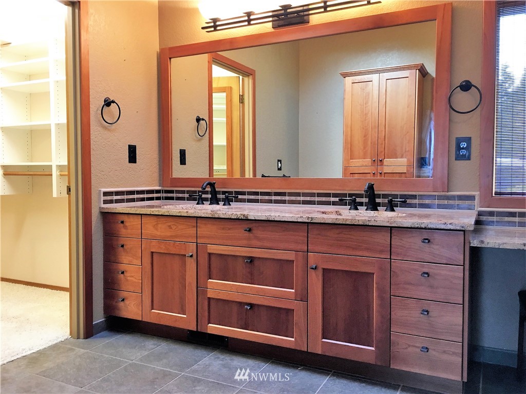5130 165th Lane Southwest Rochester, WA 98579 - Photo 14 of 25 a bathroom with a granite countertop sink and a mirror