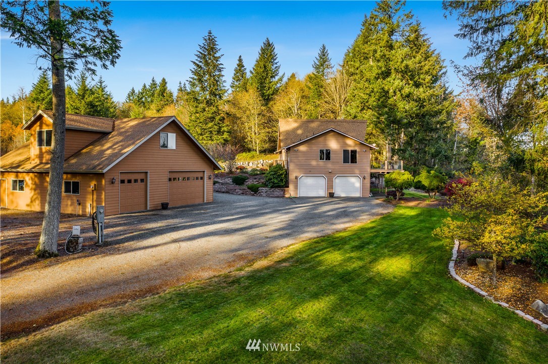 5130 165th Lane Southwest Rochester, WA 98579 - Photo 21 of 25 a front view of a house with a yard and garage