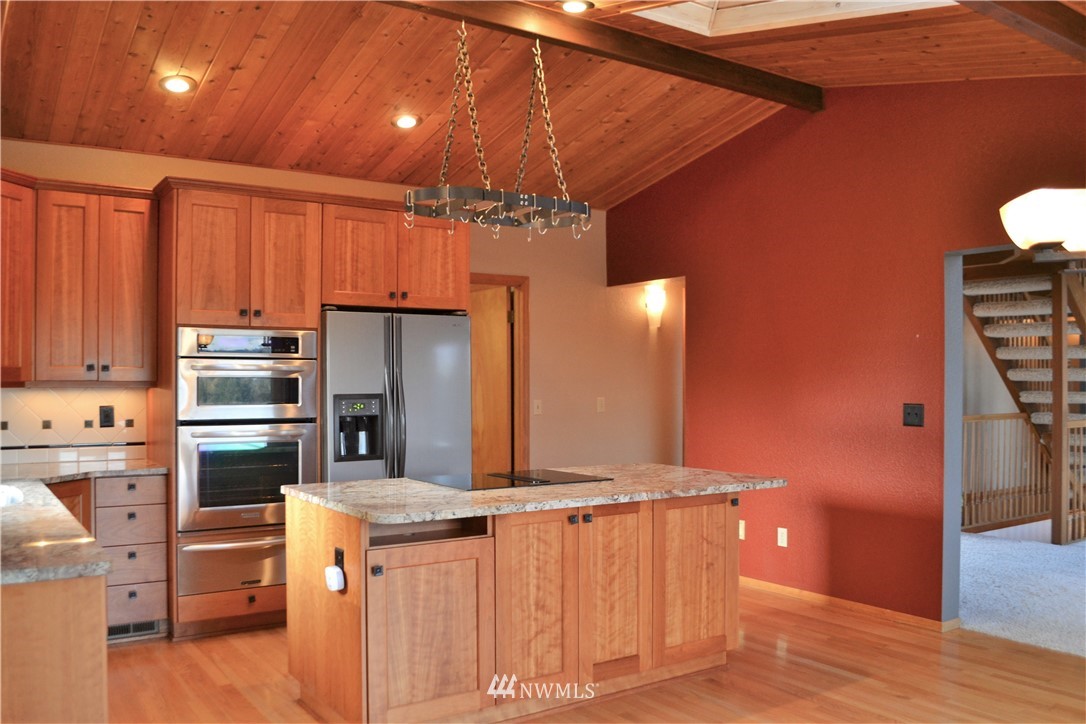 5130 165th Lane Southwest Rochester, WA 98579 - Photo 8 of 25 a kitchen with stainless steel appliances kitchen island granite countertop a refrigerator and stove