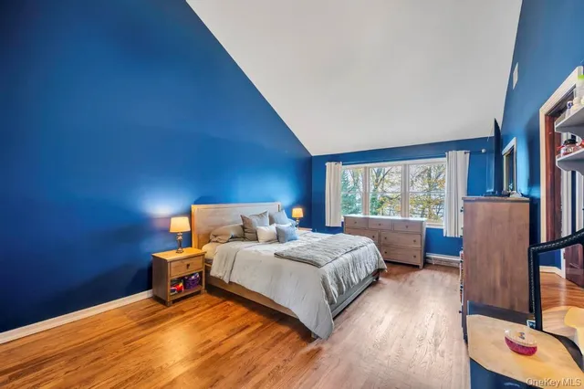 a bedroom with a bed and large mirror