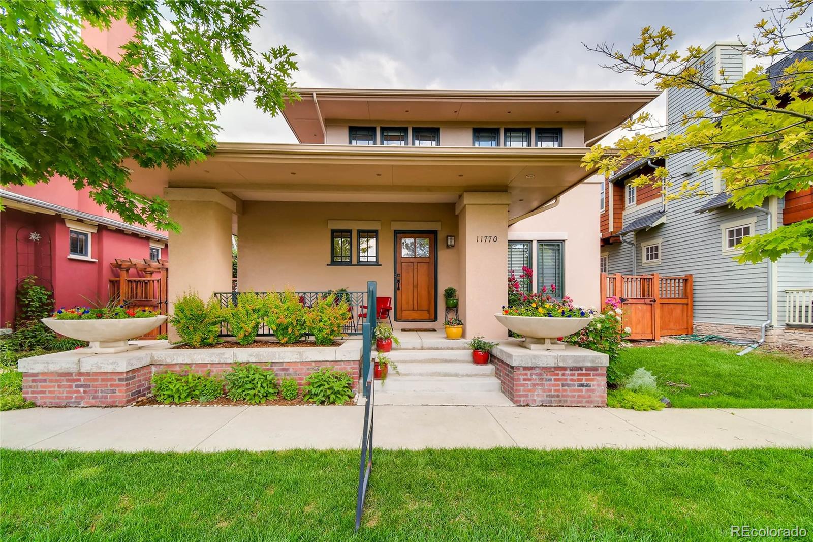 a front view of a house with a yard and outdoor seating