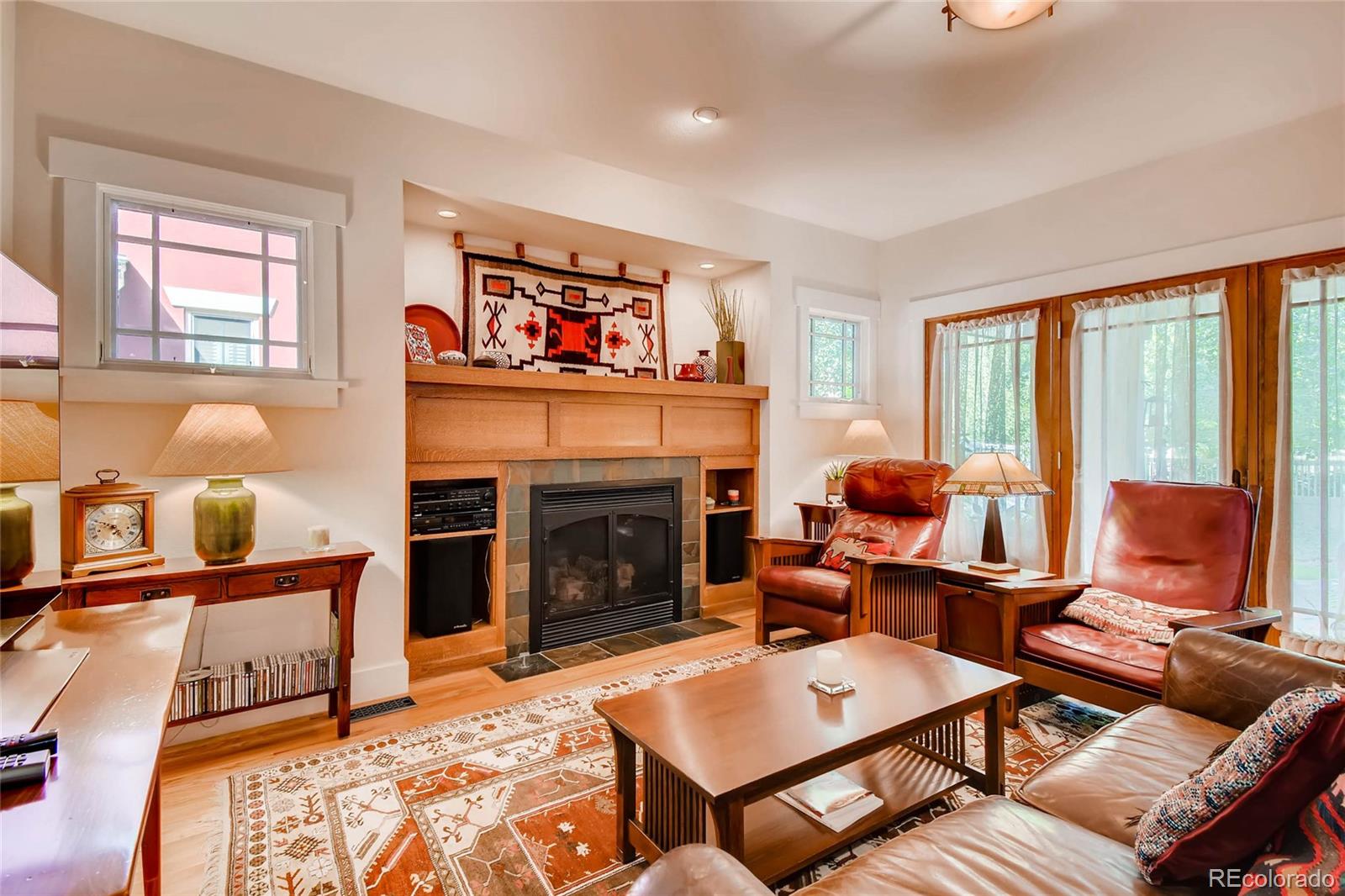 11770 Perry Street Westminster, CO 80031 - Photo 11 of 28 a living room with furniture a flat screen tv and a fireplace