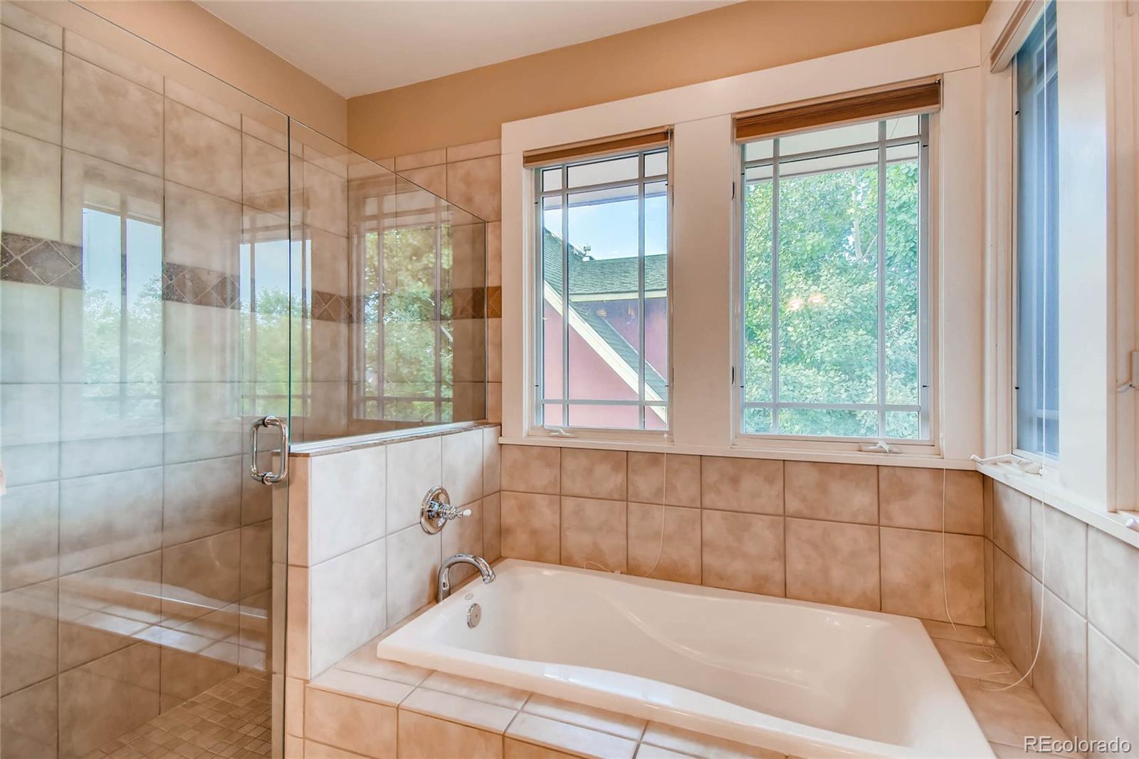 11770 Perry Street Westminster, CO 80031 - Photo 18 of 28 a bathroom with a bathtub and window