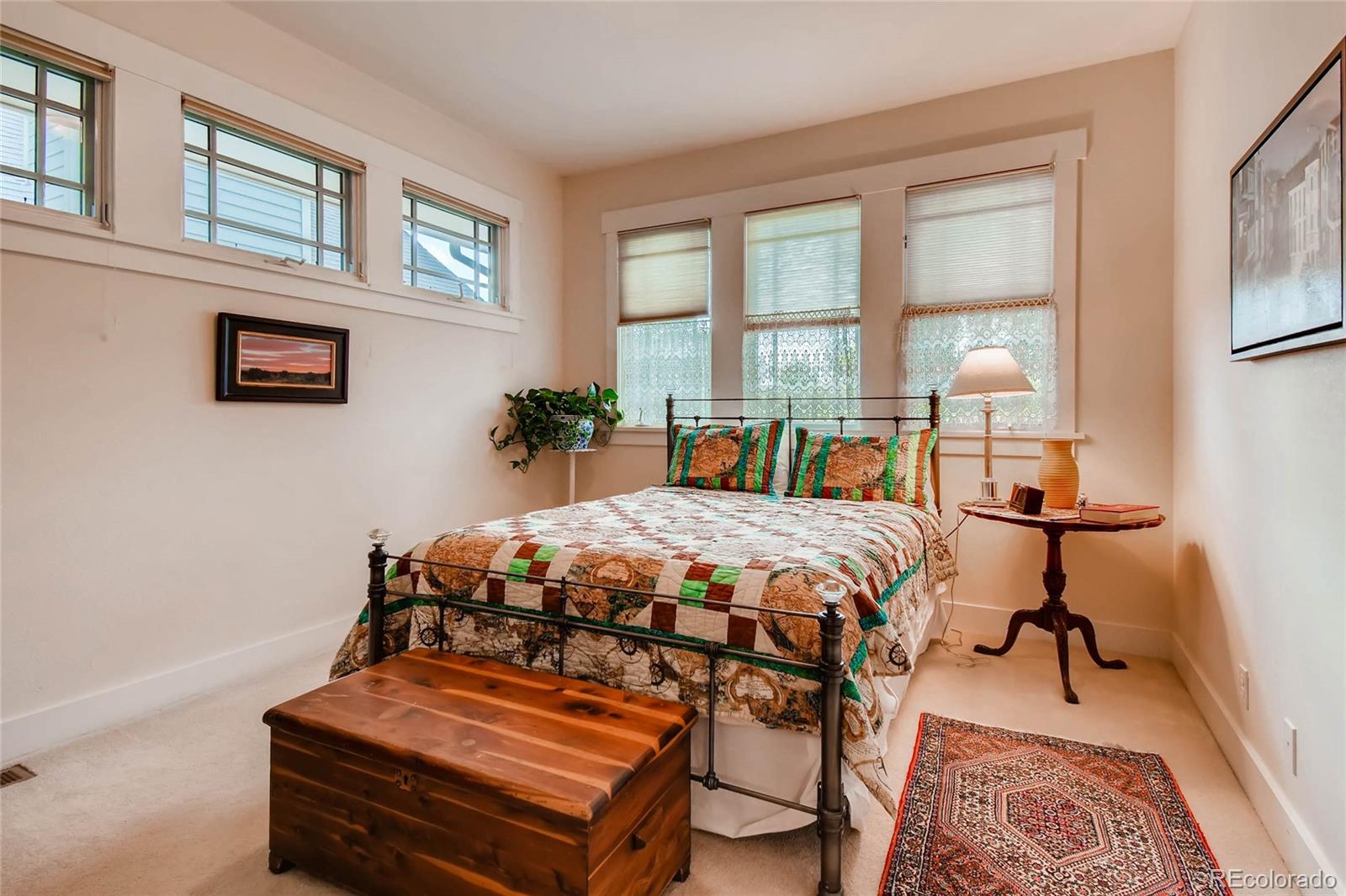 11770 Perry Street Westminster, CO 80031 - Photo 19 of 28 a bedroom with a bed a dresser and next to a window