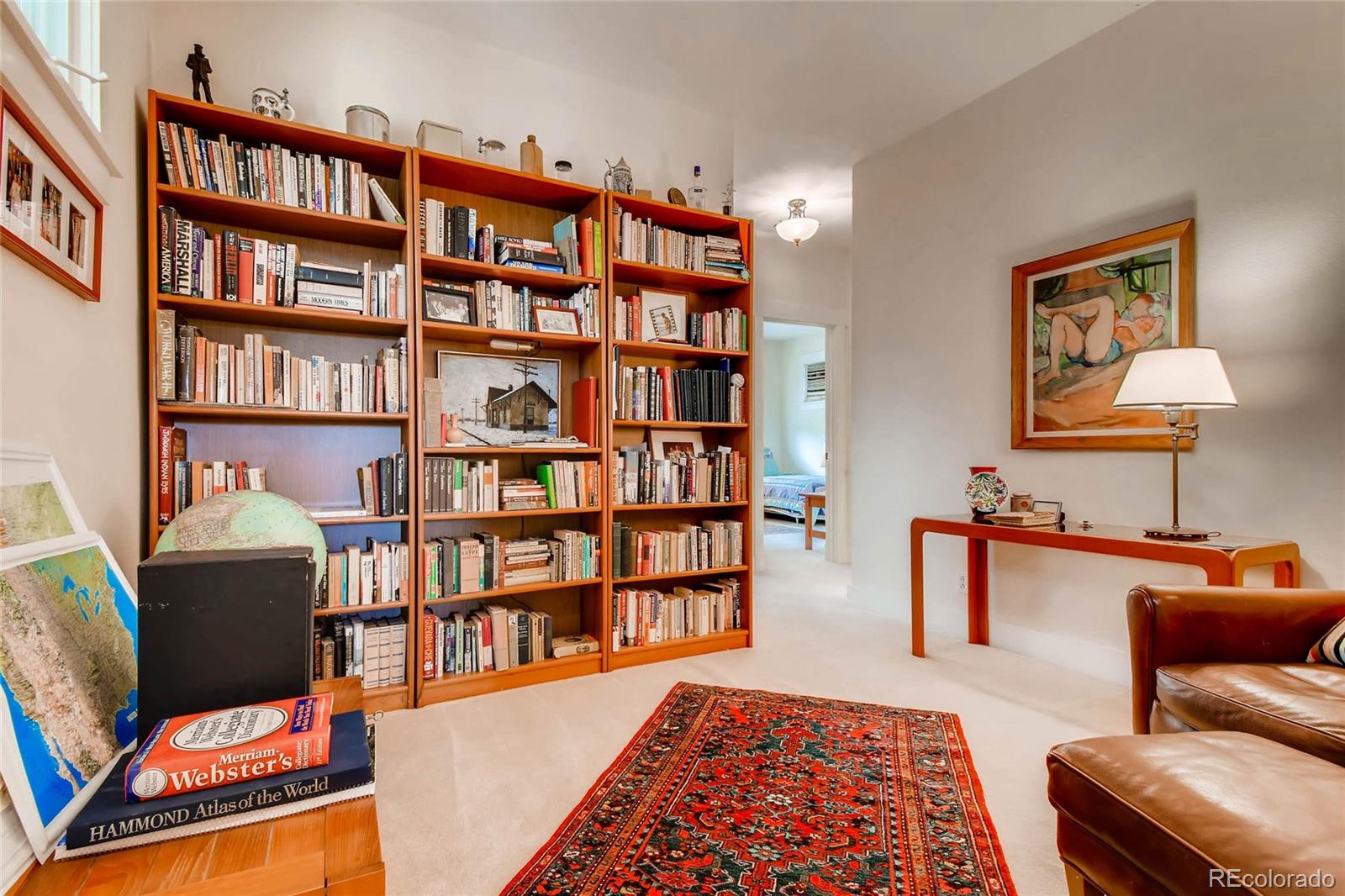 11770 Perry Street Westminster, CO 80031 - Photo 22 of 28 a living room with furniture and a book shelf
