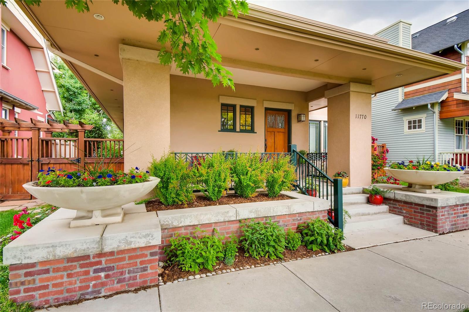 11770 Perry Street Westminster, CO 80031 - Photo 3 of 28 a view of a house with potted plants and a bench