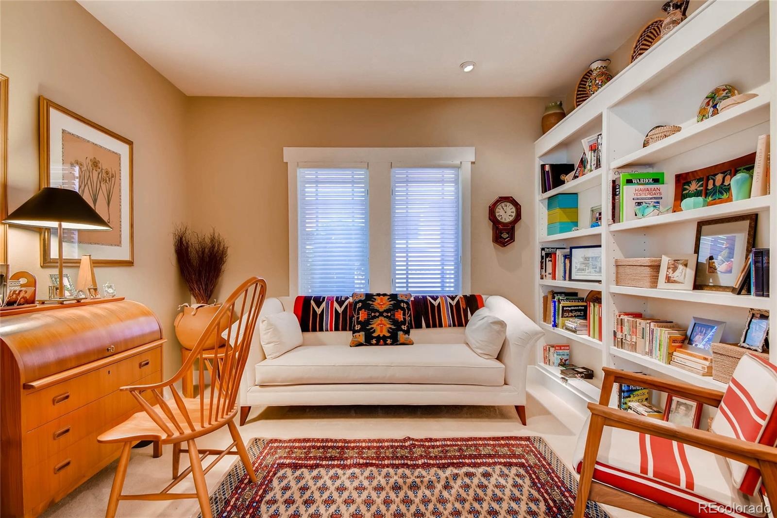 11770 Perry Street Westminster, CO 80031 - Photo 6 of 28 a bedroom with furniture and a book shelf