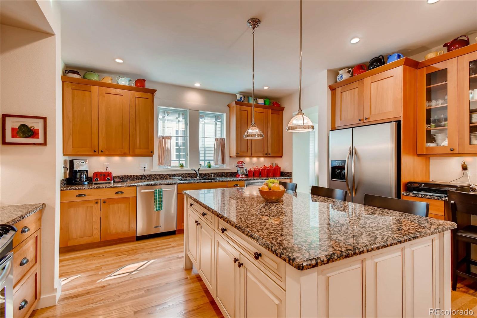 11770 Perry Street Westminster, CO 80031 - Photo 8 of 28 a kitchen with stainless steel appliances granite countertop a sink a stove and a wooden floors