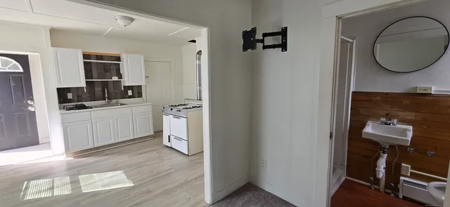 a view of a kitchen with a sink and a refrigerator