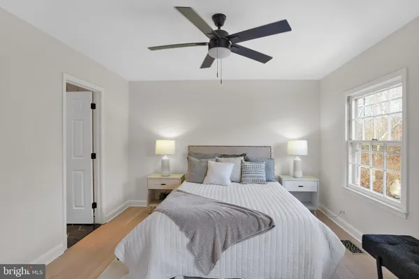 a bedroom with a bed and a large window