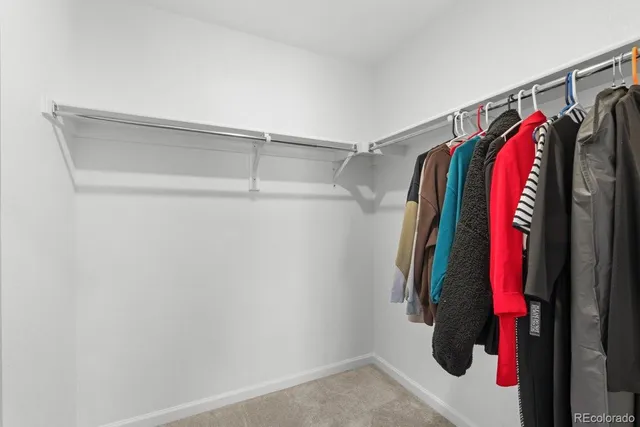 a spacious bathroom with double sink and shower