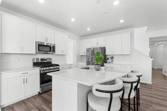 a large kitchen with a table and chairs