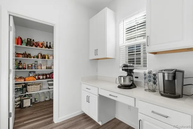 a store room with lots of clutter and cabinets