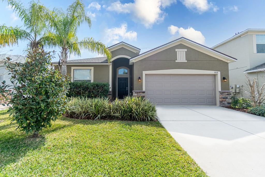 1808 Penrith Loop Orlando, FL 32824 - Photo 1 of 1 a front view of a house with a garden