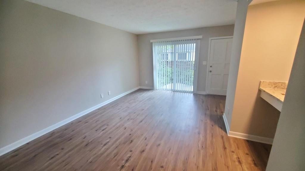 307 Adair Street, Unit B7 Decatur, GA 30030 - Photo 3 of 12 an empty room with wooden floor and windows