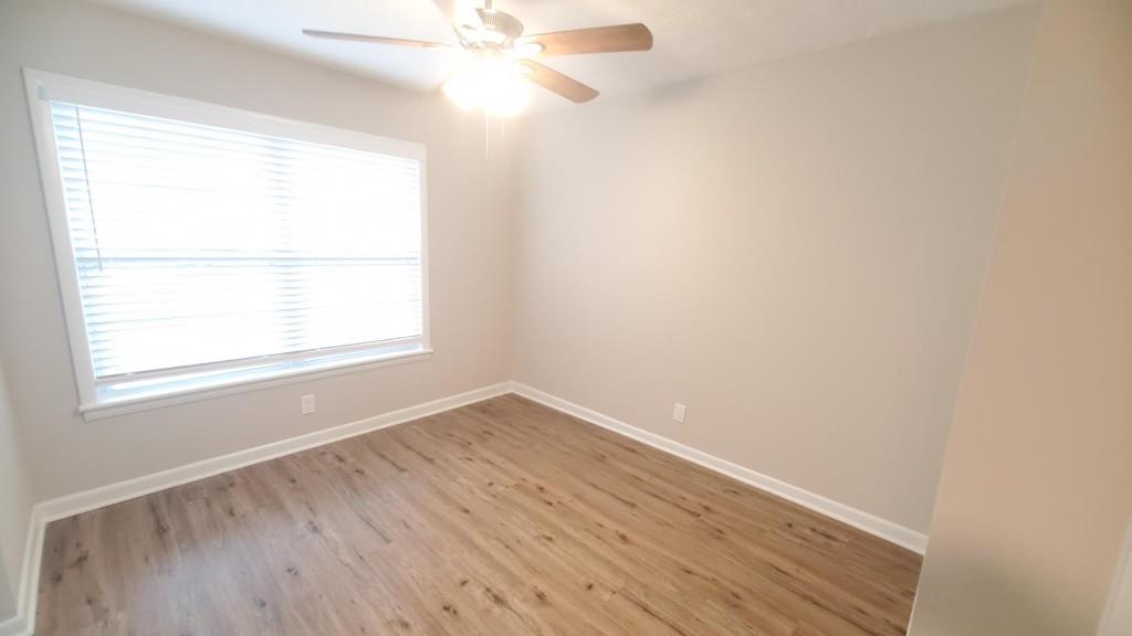 307 Adair Street, Unit B7 Decatur, GA 30030 - Photo 5 of 12 an empty room with wooden floor and windows