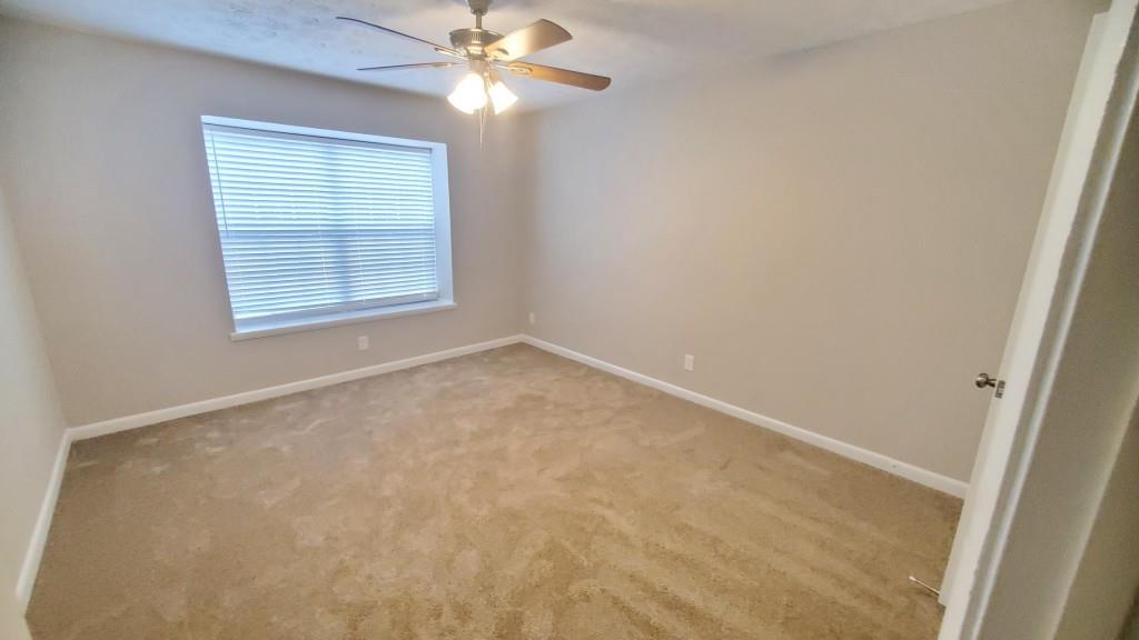 307 Adair Street, Unit B7 Decatur, GA 30030 - Photo 9 of 12 an empty room with a window and a fan