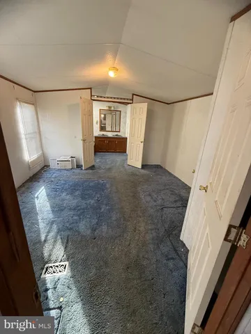 a view of a big room with wooden floor and cabinet