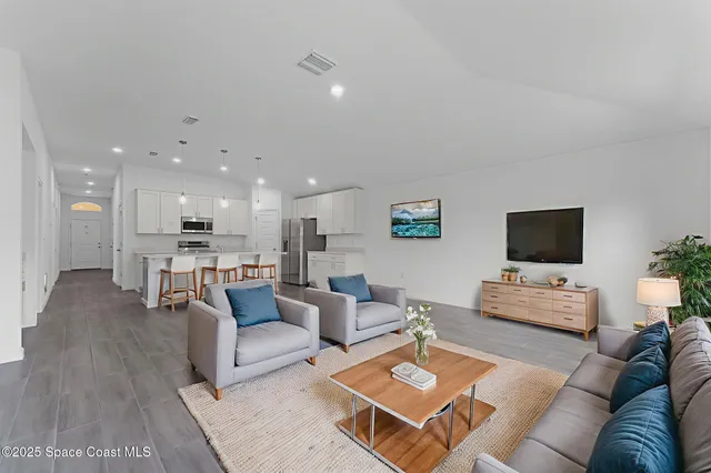 a living room with furniture and a flat screen tv