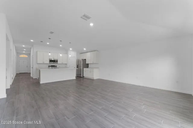 a view of a kitchen with a sink and a microwave