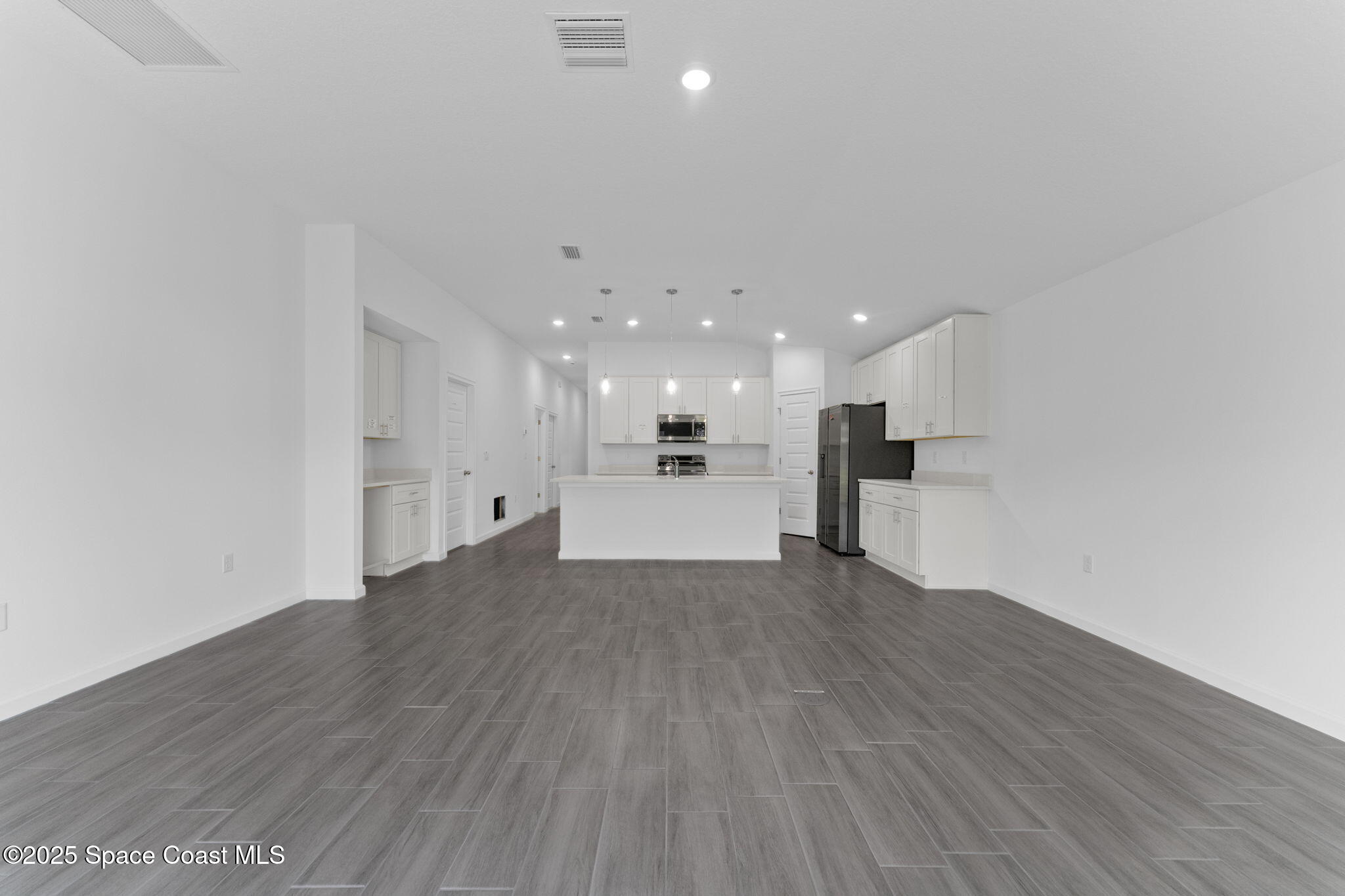 101 Crosspoint Street Southeast Palm Bay, FL 32909 - Photo 13 of 28 a view of a kitchen with a sink and wooden floor