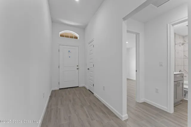 a view of a hallway with wooden floor