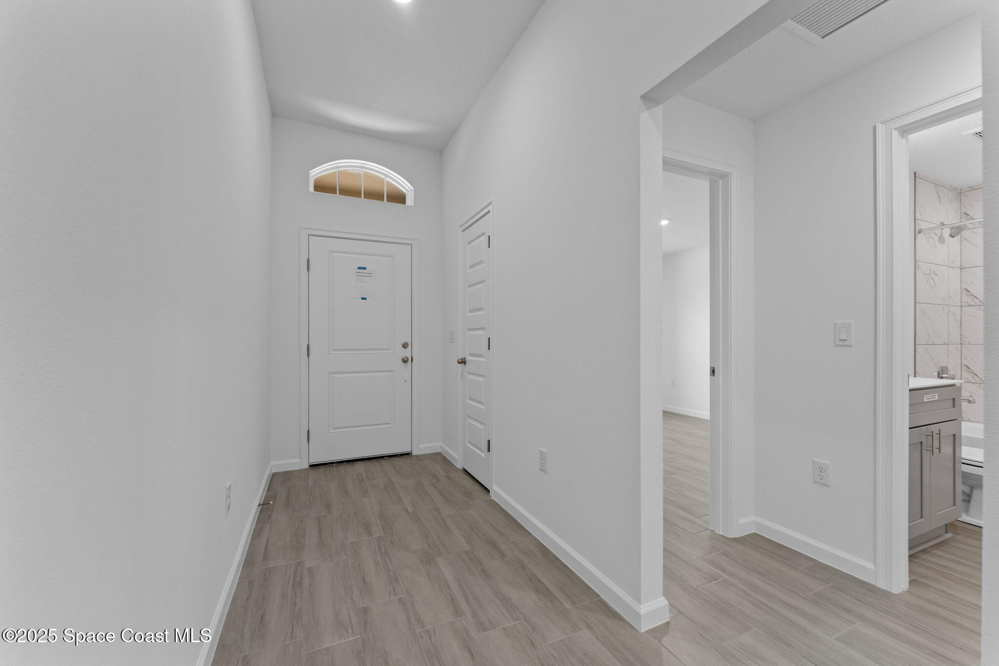 101 Crosspoint Street Southeast Palm Bay, FL 32909 - Photo 2 of 28 a view of a hallway with wooden floor