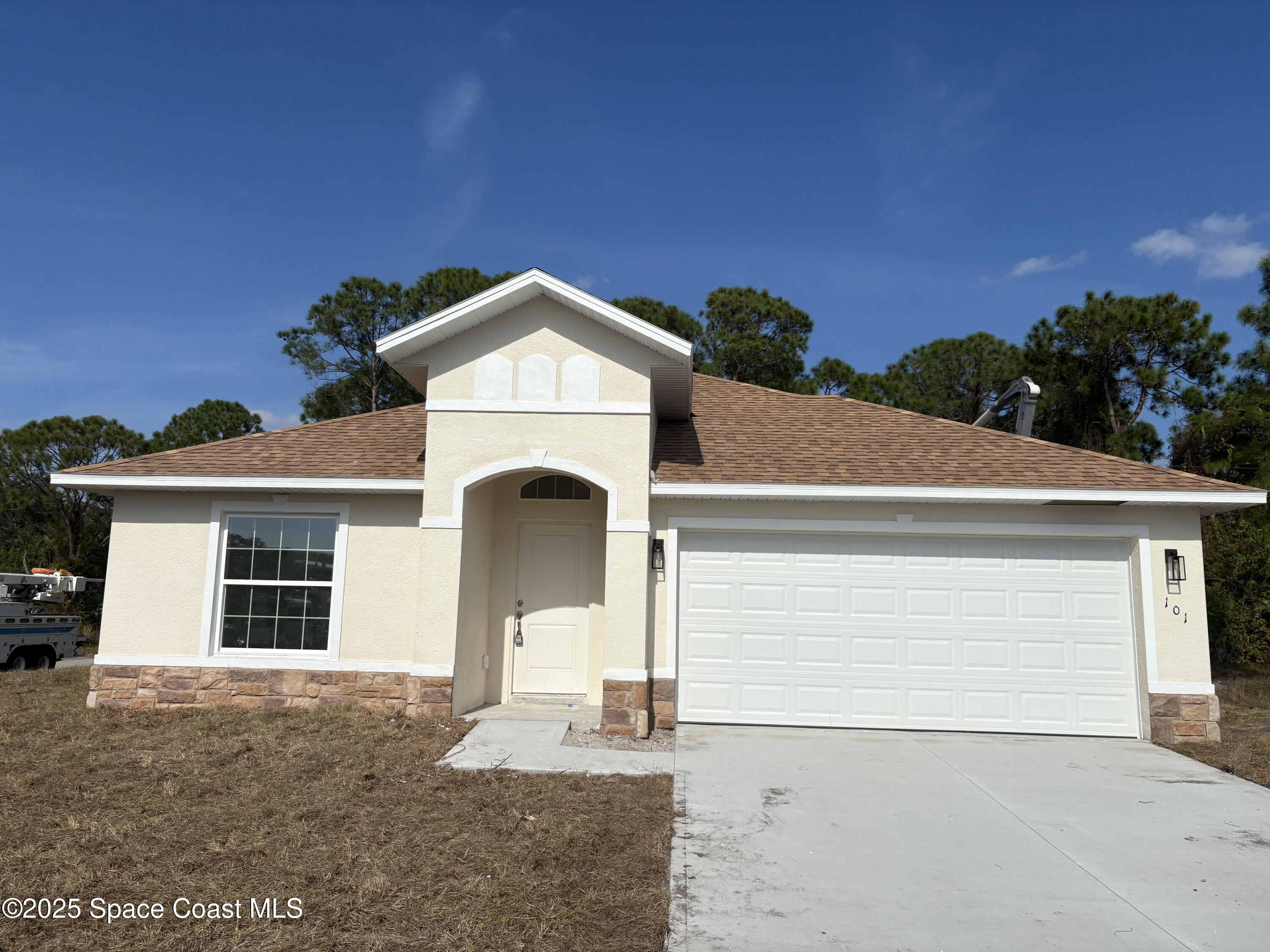 101 Crosspoint Street Southeast Palm Bay, FL 32909 - Photo 27 of 28 a front view of a house with a yard and garage