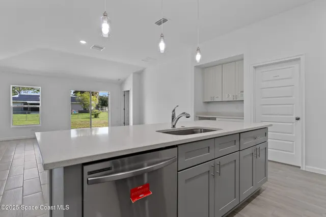 a kitchen with a sink and cabinets