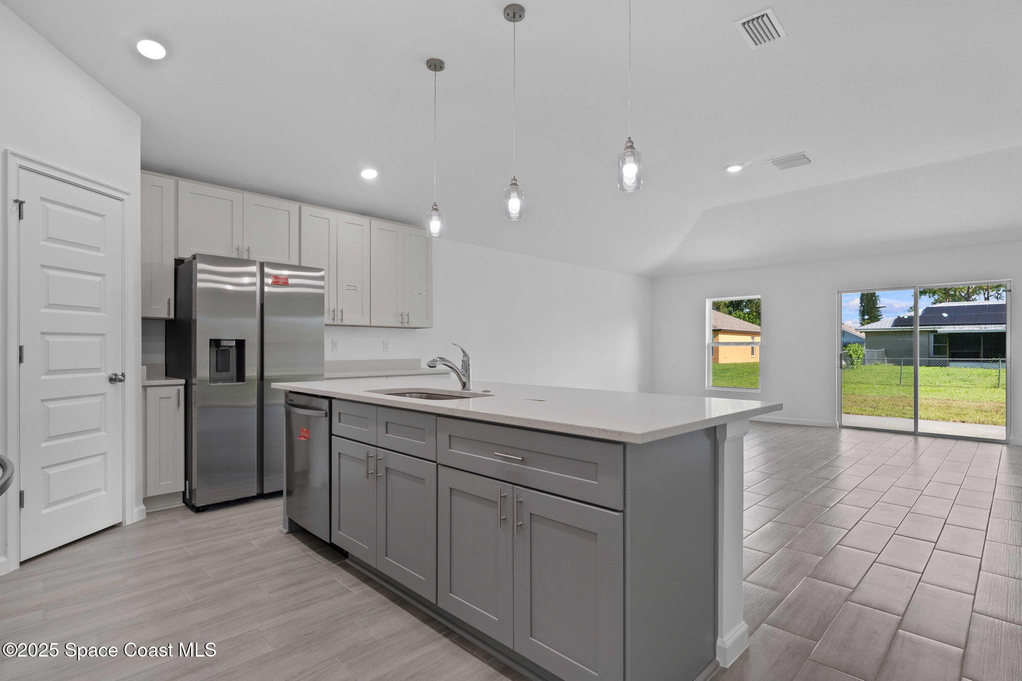 101 Crosspoint Street Southeast Palm Bay, FL 32909 - Photo 8 of 28 a kitchen with kitchen island a sink a stove and refrigerator