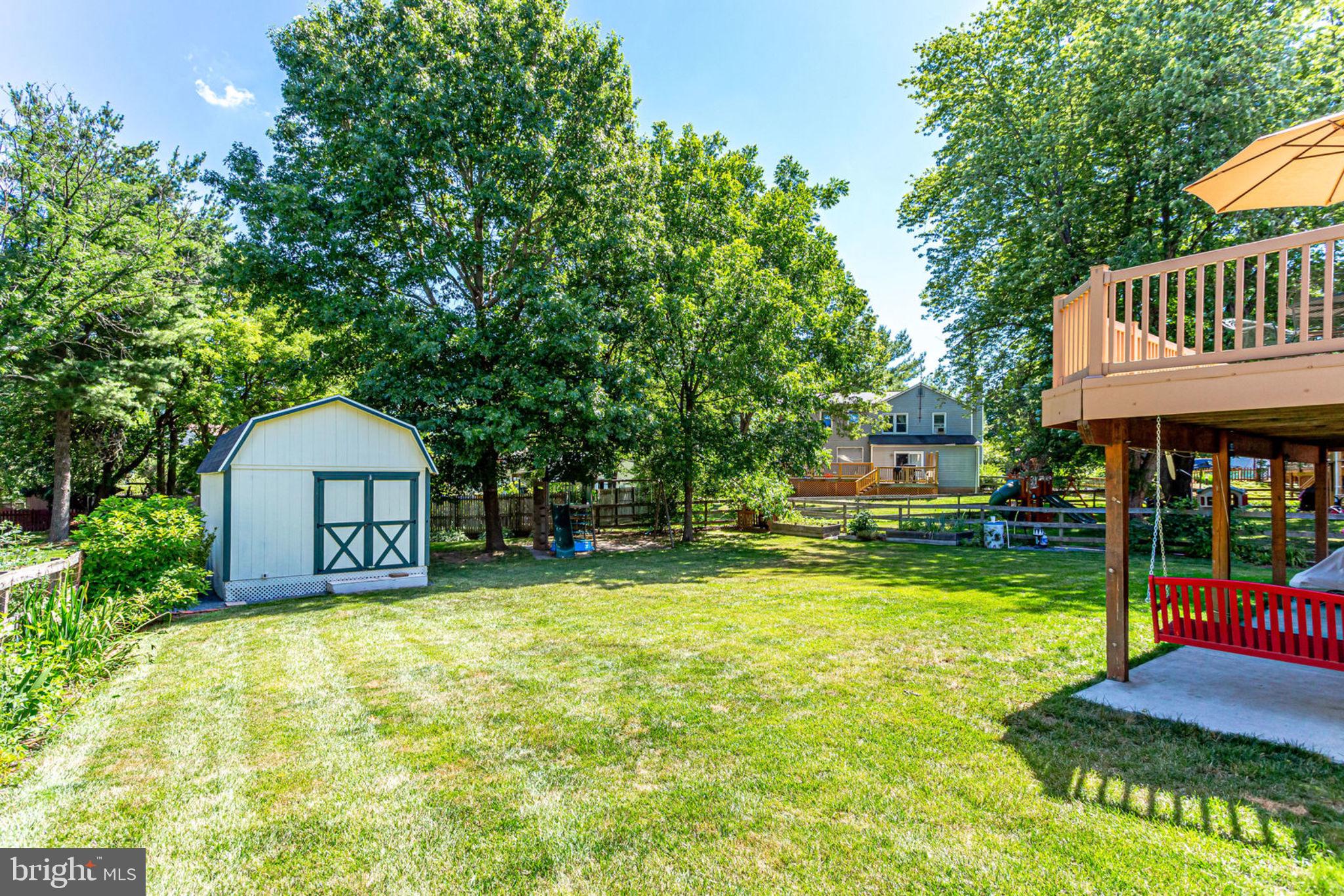 4305 Cub Run Road Chantilly, VA 20151 - Photo 40 of 46 a front view of a house with a yard fountain and large tree