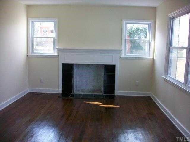 1110 East Martin Street Raleigh, NC 27610 - Photo 4 of 11 Great and sunny Family Room. New windows, refinished hardwoods, new tile around the fireplace. Den/Family/Great Room