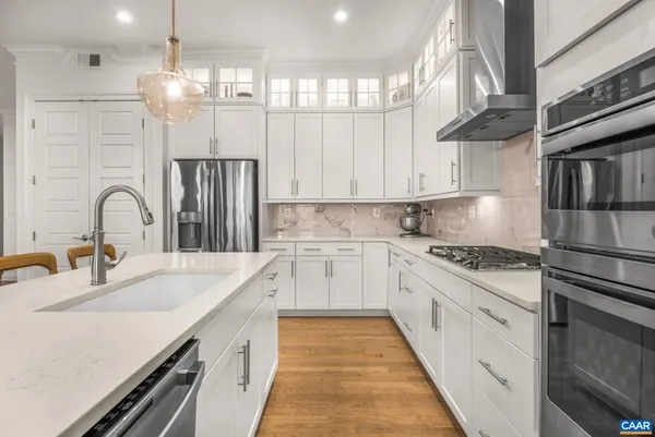 a kitchen with stainless steel appliances granite countertop a white cabinets and a sink