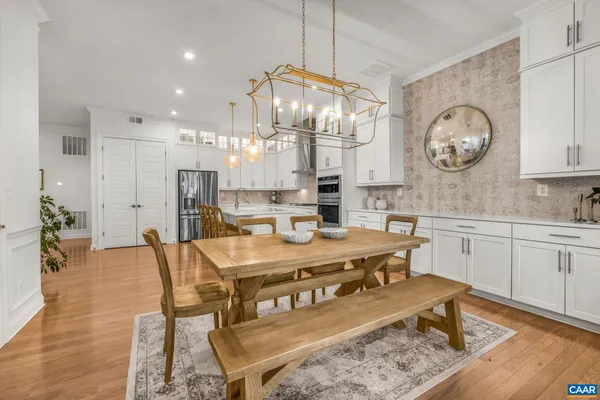 a view of a hallway with wooden floor and furniture