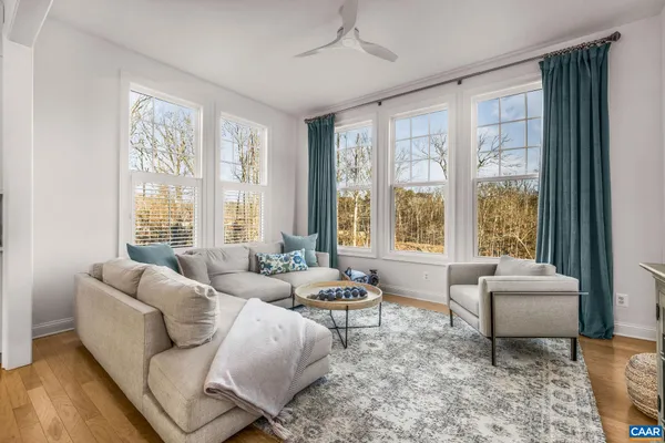 a bed room with furniture and a flat screen tv