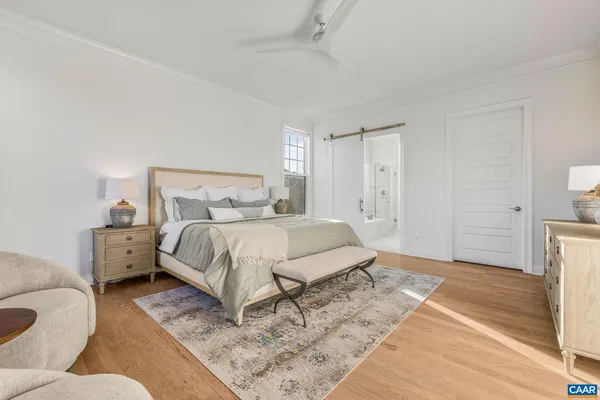 a bedroom with a bed a dresser and window