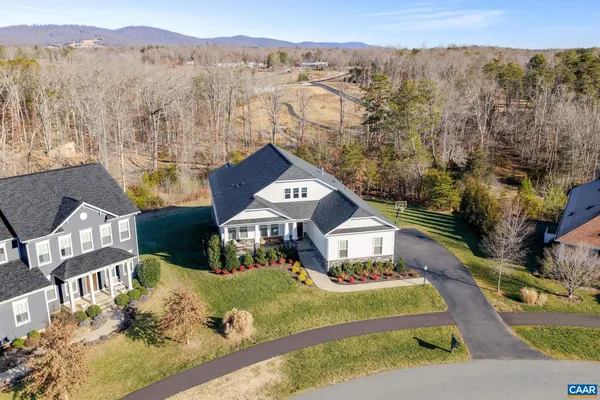 a living room with fireplace furniture and a view of kitchen