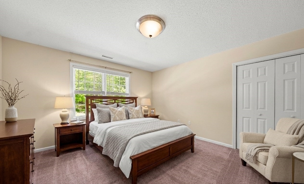 1507 East Mountain Road Westfield, MA 01085 - Photo 28 of 42 a bedroom with a bed and a chandelier