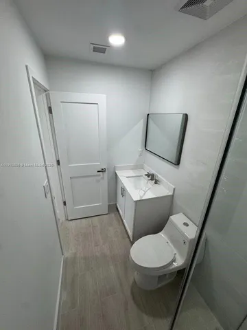 a white toilet sitting next to a bathroom sink