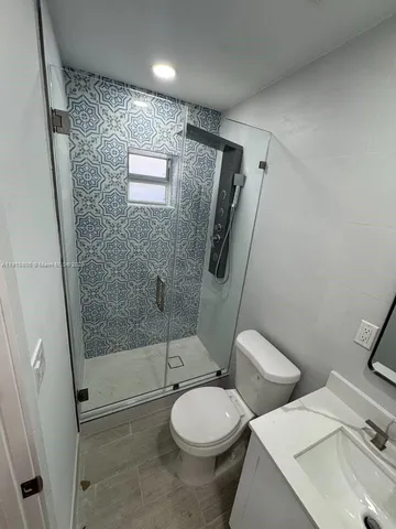 a bathroom with a toilet and a shower