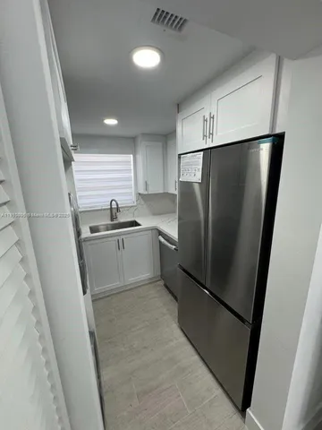 a kitchen with refrigerator a sink and dishwasher