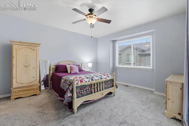 a spacious bedroom with a bed and a chandelier
