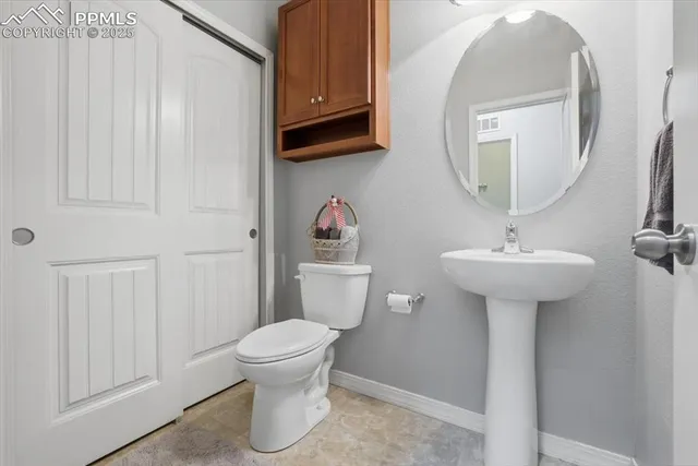 a bathroom with a sink toilet and a mirror