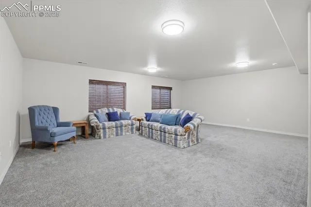 a living room with furniture and a chair