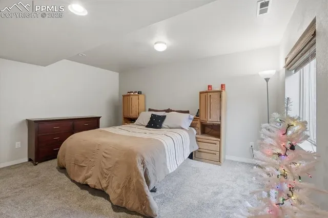 a spacious bedroom with a bed and a chandelier
