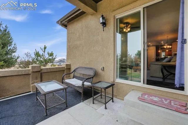 a balcony with table and chairs