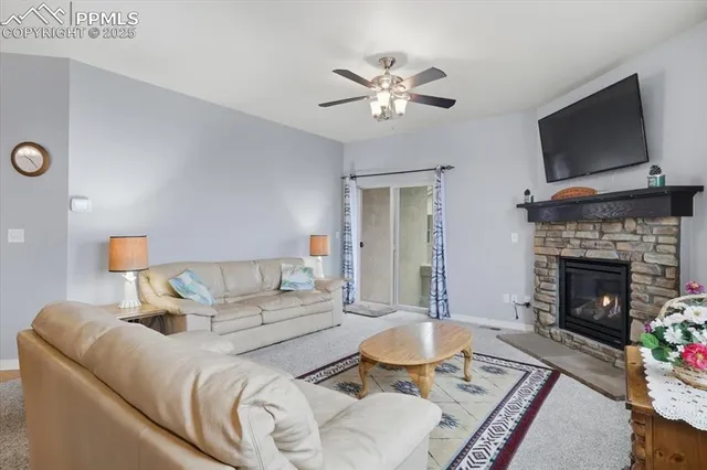 a living room with furniture a fireplace and a flat screen tv