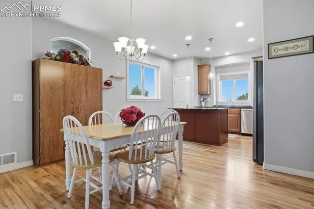 a dining room with furniture and chandelier